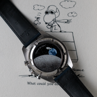 Caseback of Omega Speedmaster 50th Anniversary Snoopy, Snoopy in his spacecraft flying over the Moon and the Earth